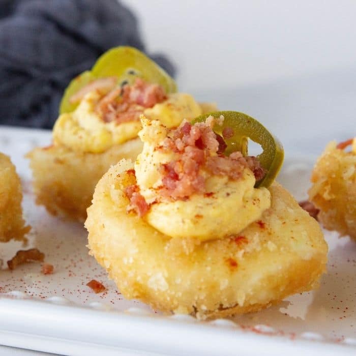 deviled eggs with bacon and jalapeno on platter