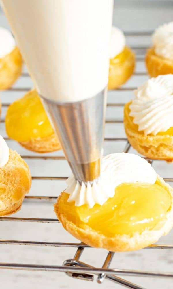 piping whipped cream on cream puff