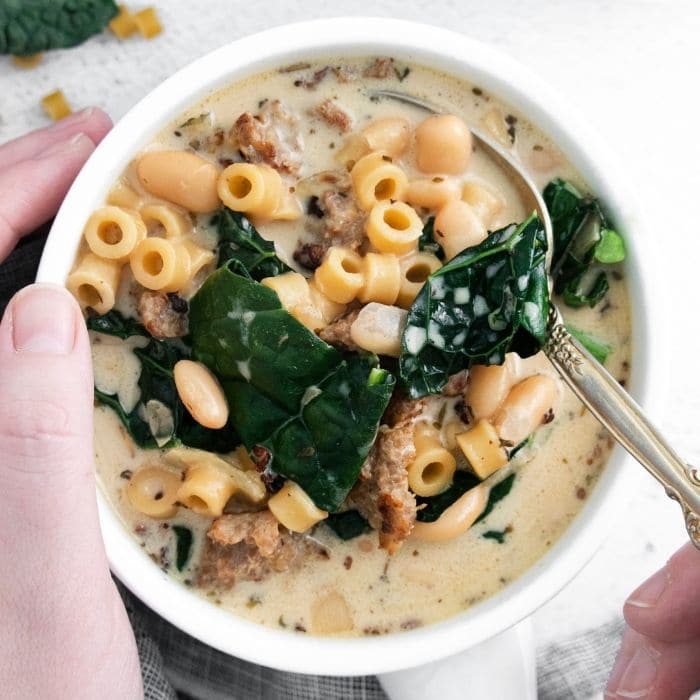 Instant Pot Pasta E Fagioli Soup in a bowl being held with spoon