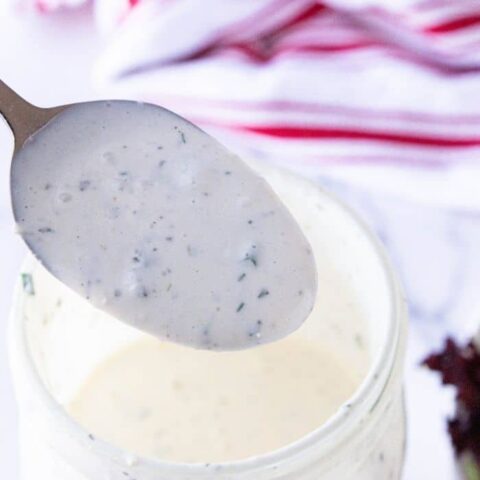jar with homemade dressing on a spoon