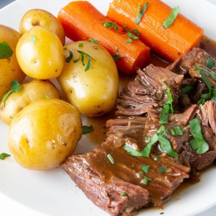 roast and potatoes and carrots on a plate 