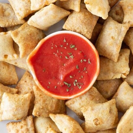 pizza rolls on plate with sauce in middle