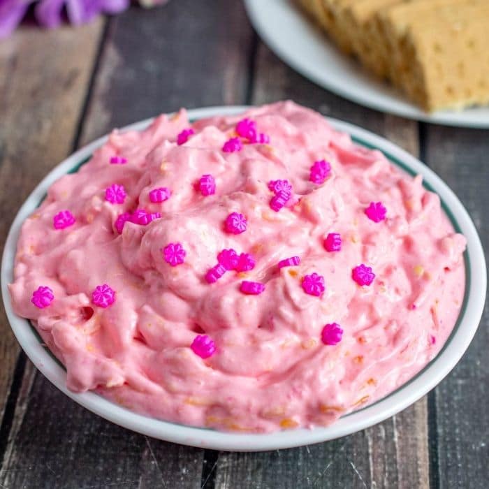 pink fruit and dessert dip on wooden table