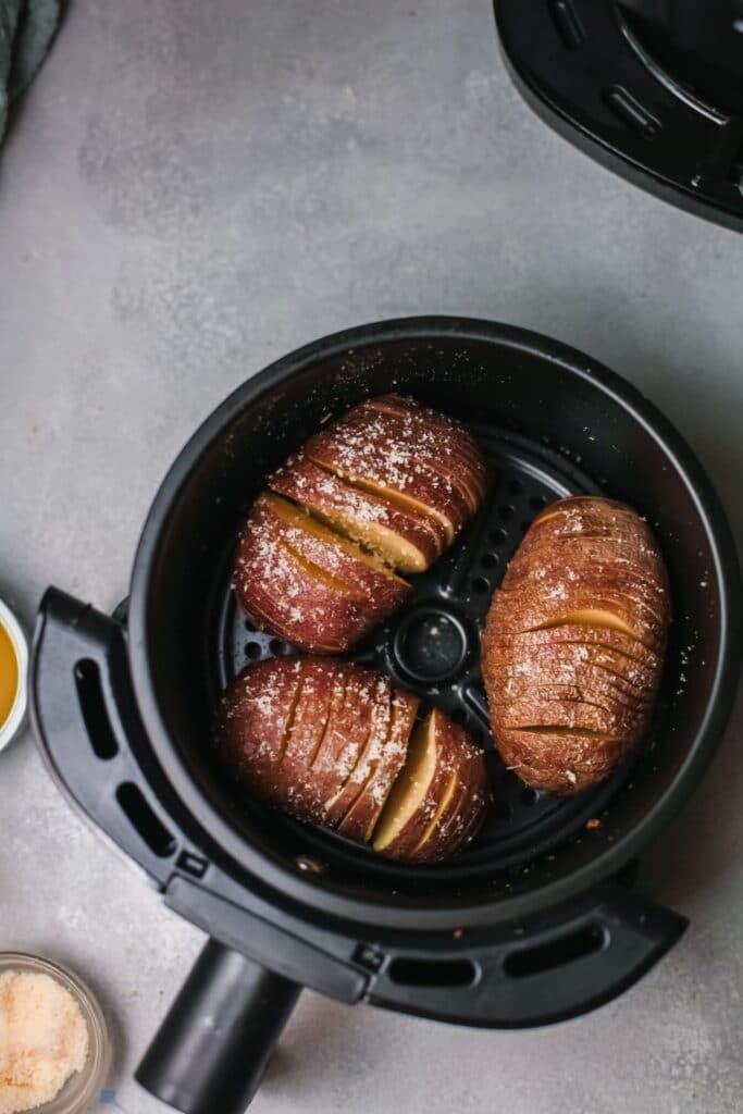 air fryer hasselback potatoes in air fryer basket, overhead shot