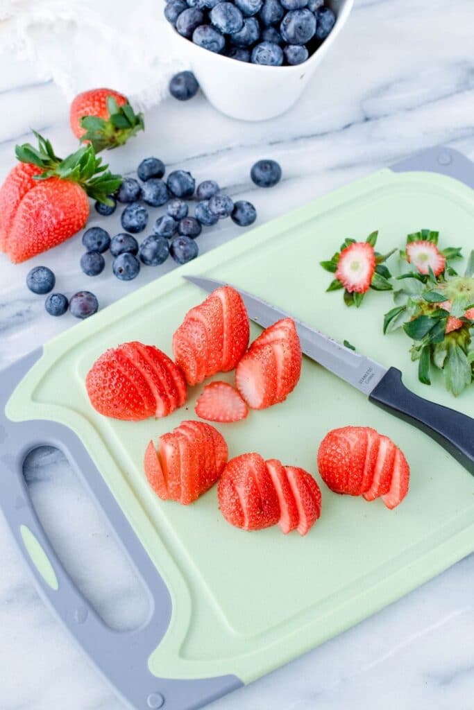 sliced berries on a cutting board