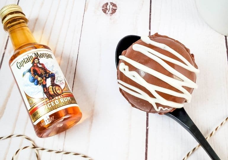 boozy cocoa ball on a spoon with rum by it