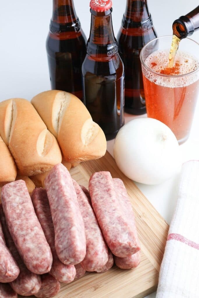 raw brats, buns, and beer on counter