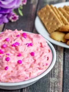 Pink dessert ip with graham crackers and cookies on table
