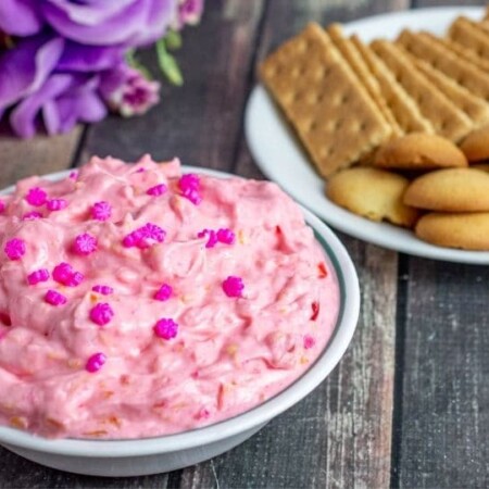 Pink dessert ip with graham crackers and cookies on table