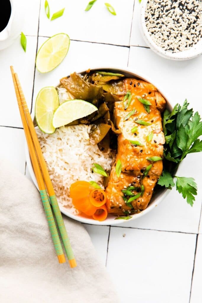 glazed salmon in a bowl with chopsticks 