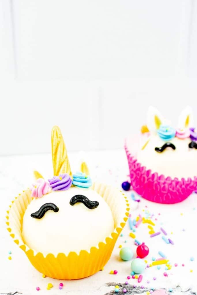 yellow and pink cocoa unicorn bombs on white table