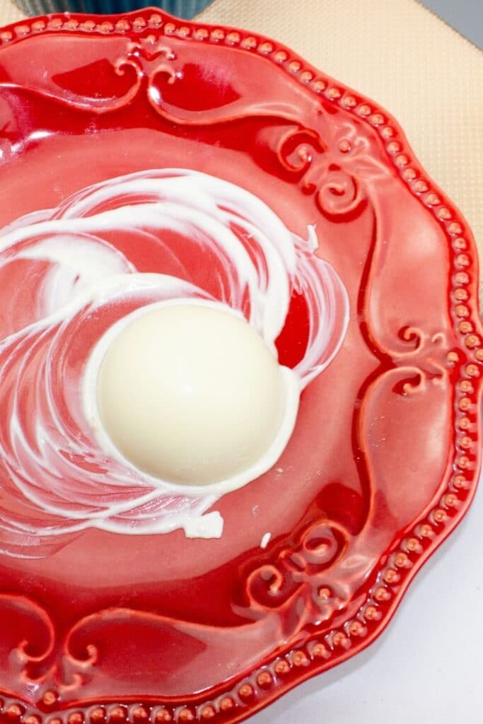 white chocolate on a red plate with some melted 