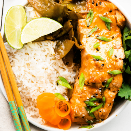 salmon rice bowl with chopsticks by it, overhead view of bowl