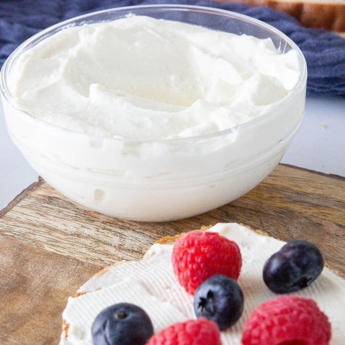 cream cheese spread on bread with fresh berries. 