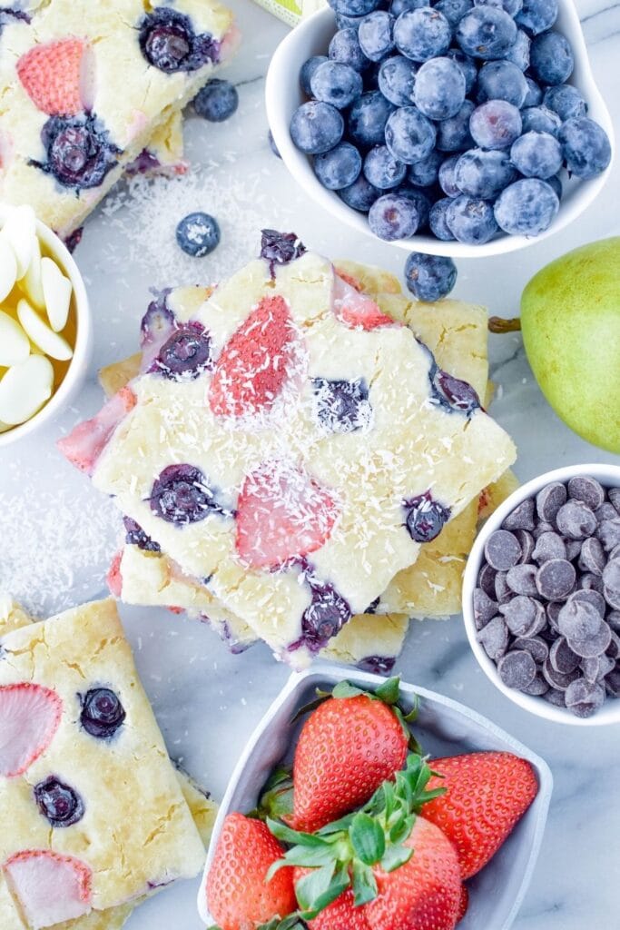 pancakes on table with fresh fruit and stuff around it 