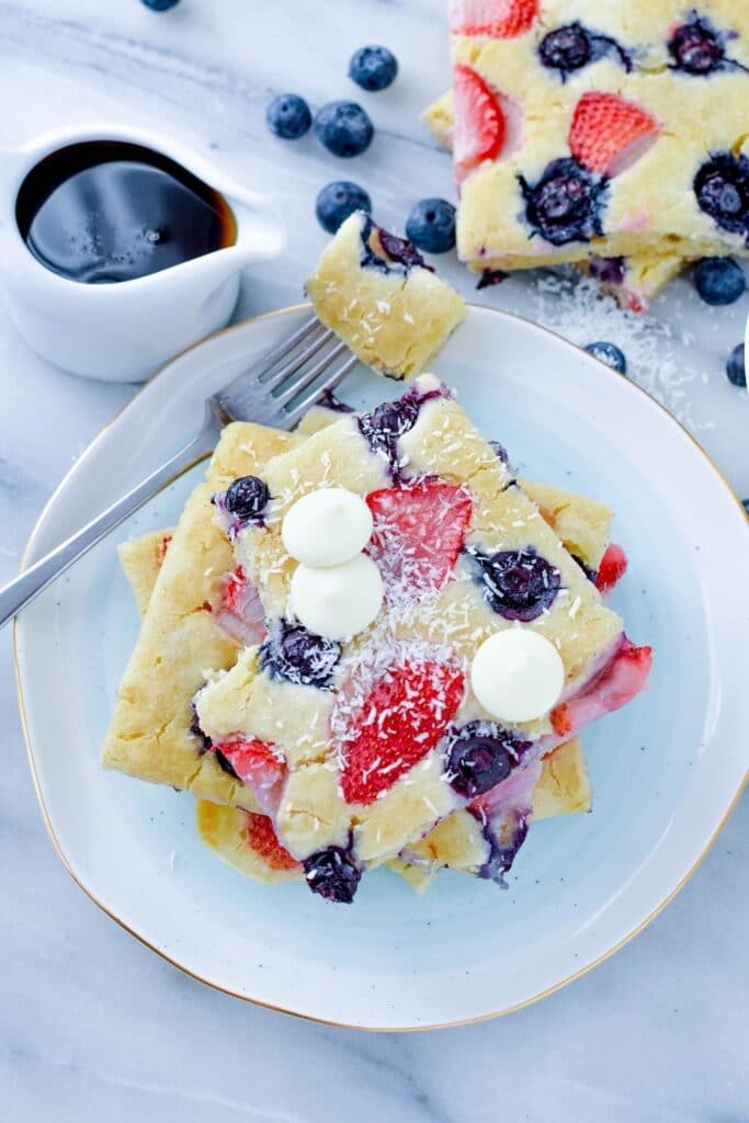 sliced sheet pan pancakes on plate with piece taken out