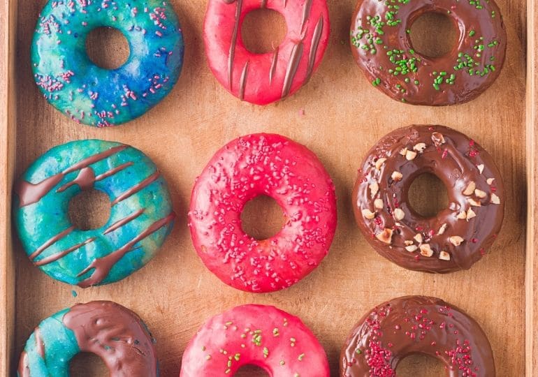 wooden plate with donuts on it