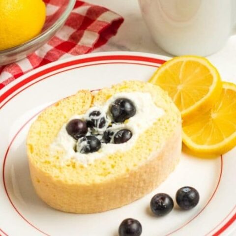 lemon loaf on a plate with blueberries