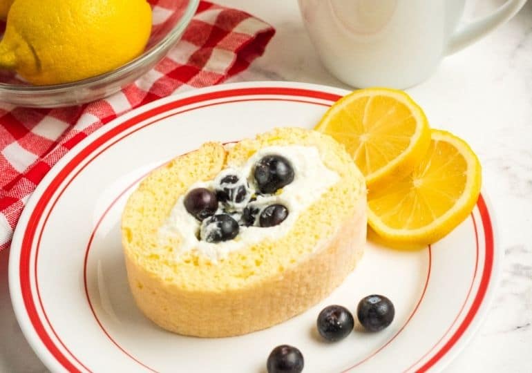 lemon loaf on a plate with blueberries