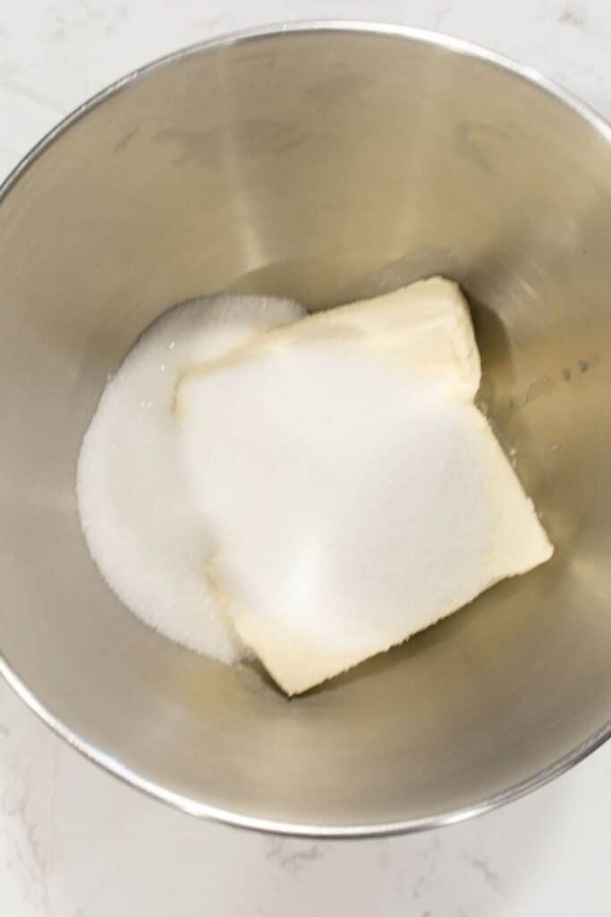 cream cheese and sugar in a mixing bowl 