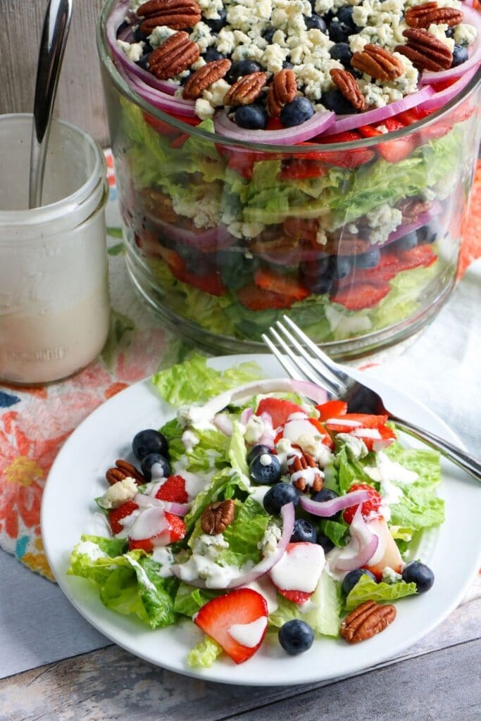 summer salad on a plate with dressing on top 