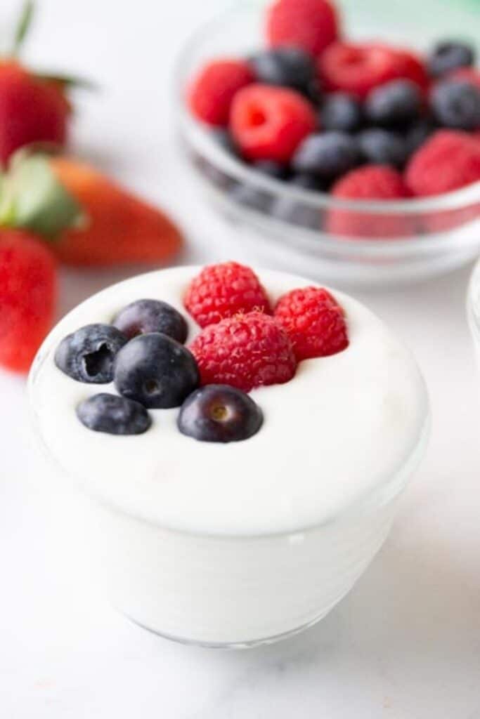 yogurt with berries on top 