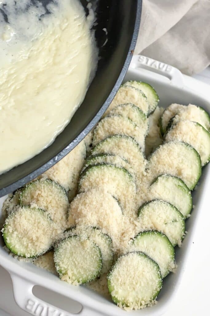 pouring sauce over zucchini