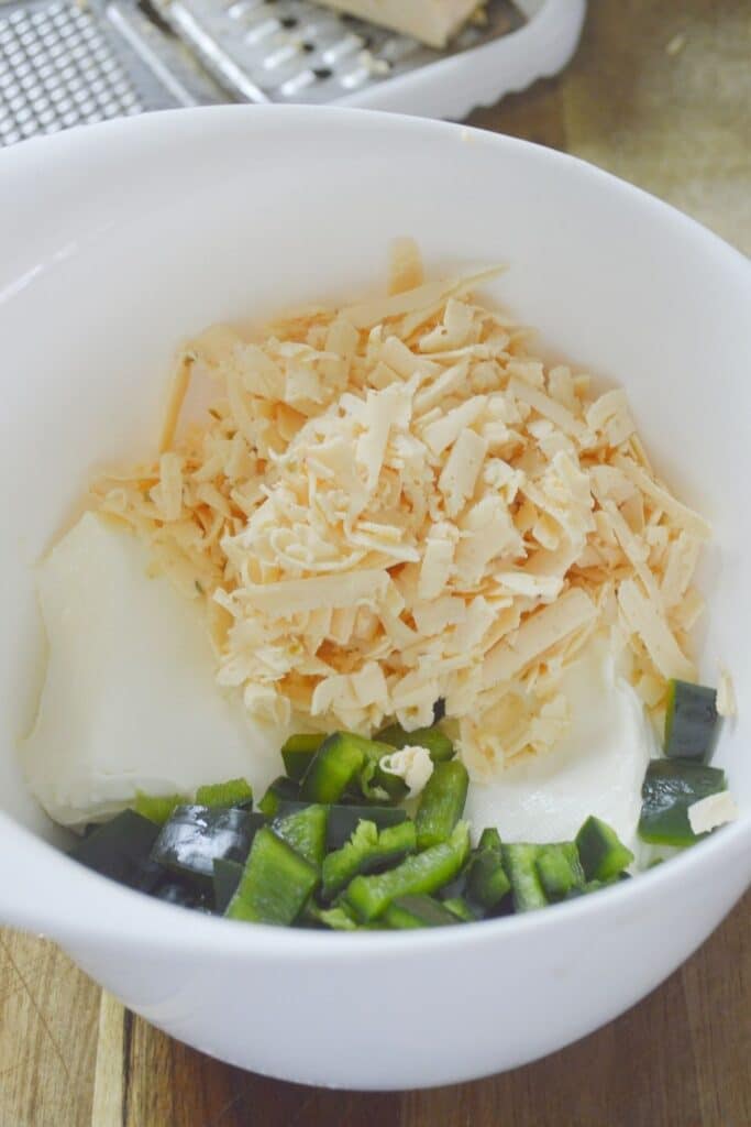 shredded cheese, cream cheese and peppers in bowl 