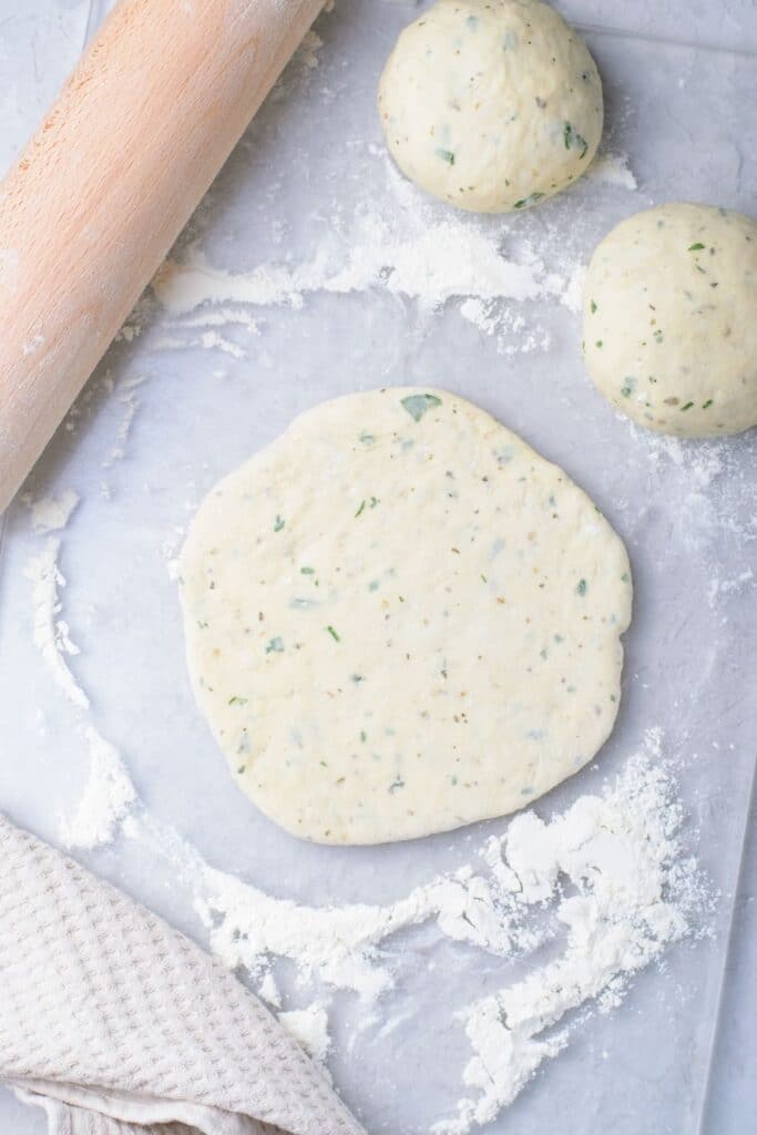 Flatbread with Herbs rolled out on table