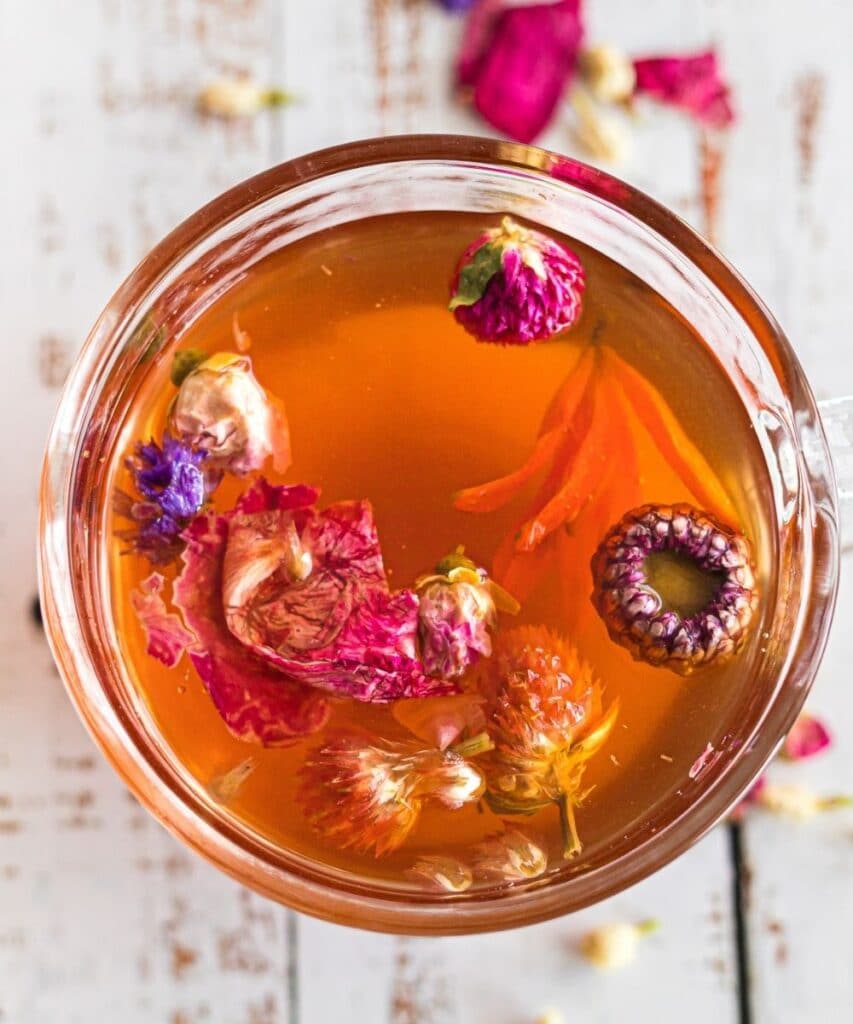 mug with tea and edible flowers in it, overhead shot