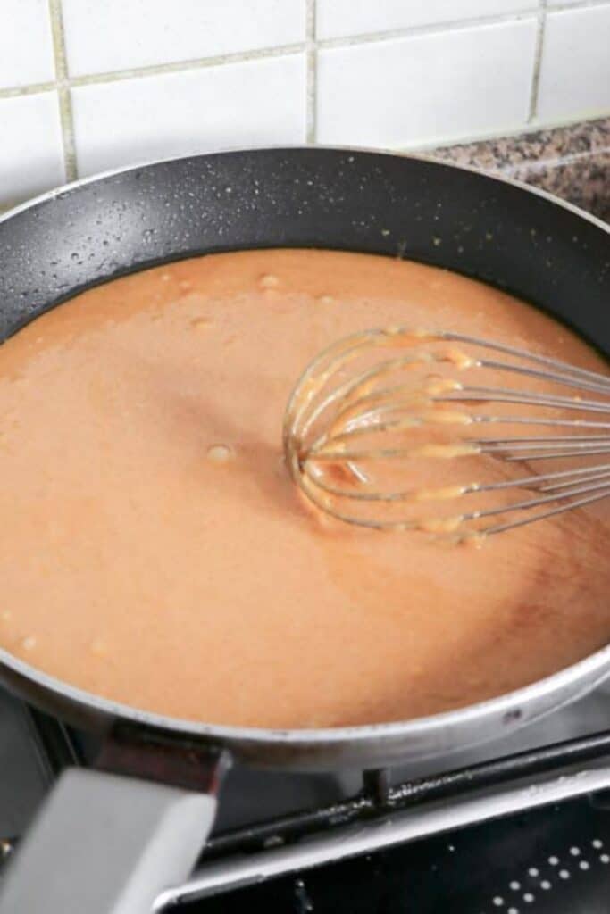 mixing up a toffee mixture in a pan on the stove 