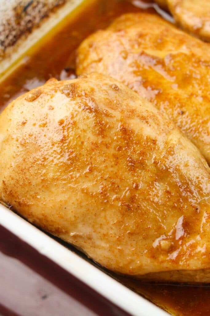 closeup of cooked boneless chicken in baking dish 