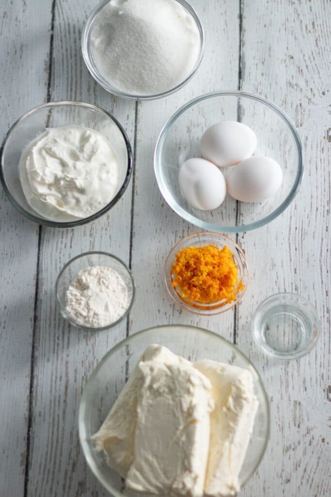 ingredients for cheesecake on wooden table 