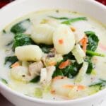 chicken gnocchi soup in a white bowl on table