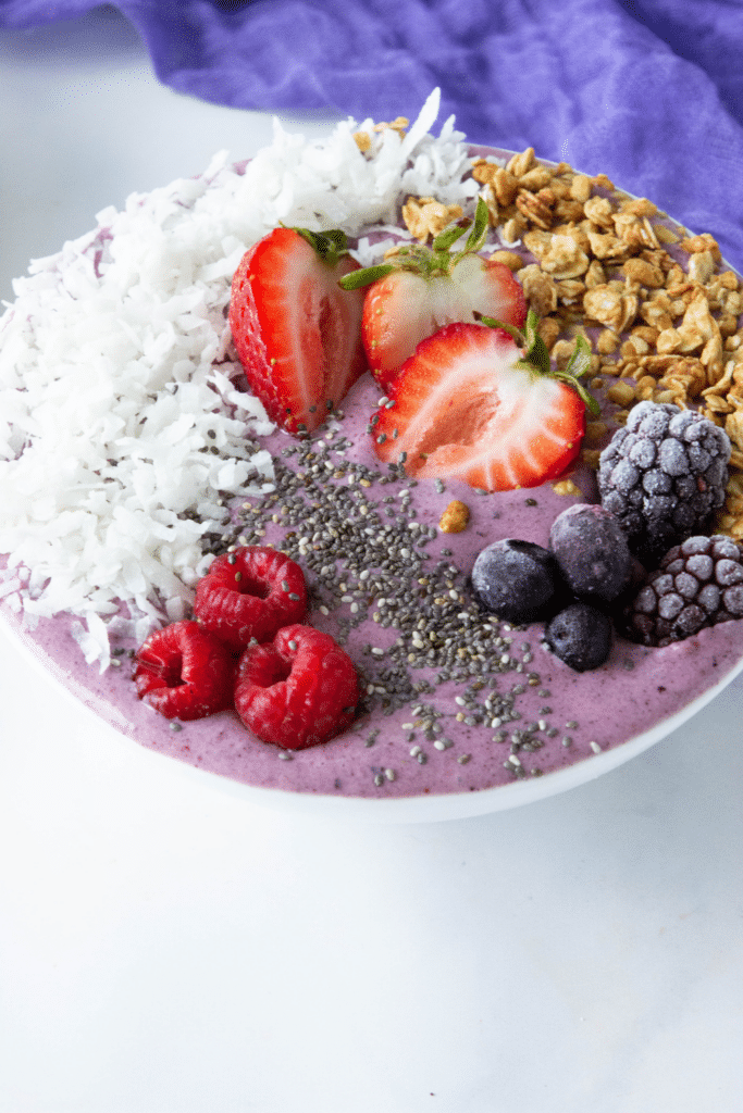 berry acai bowl on marble counter 