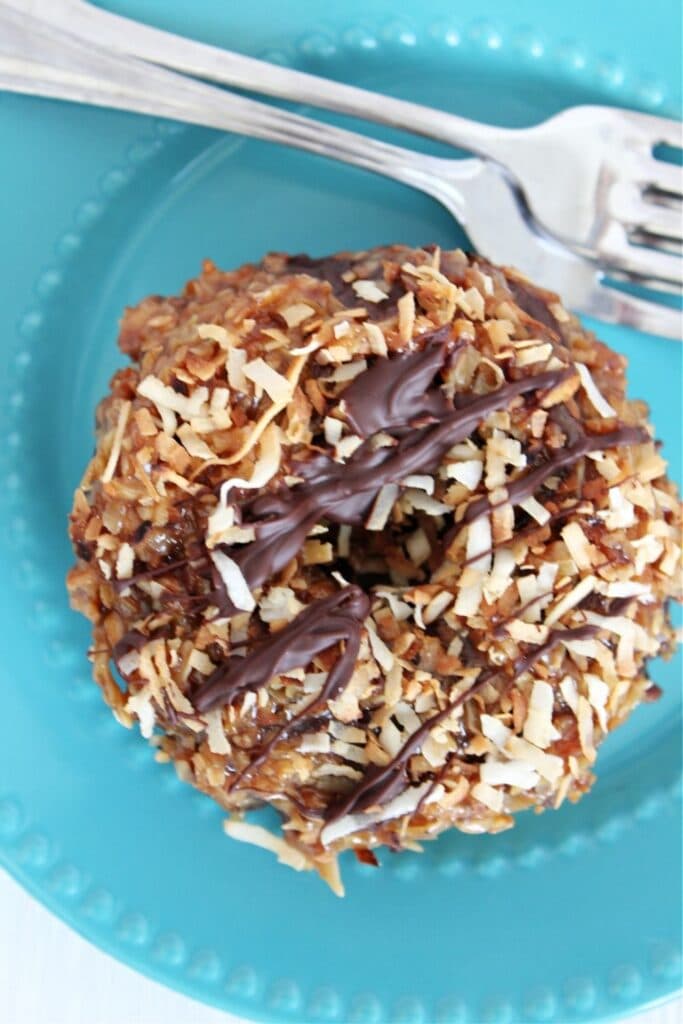 donut on blue plate with fork by it 