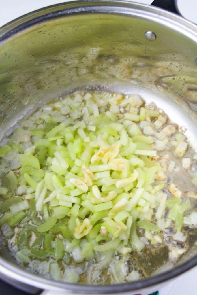 onions, celery, and oil in pan cooking 