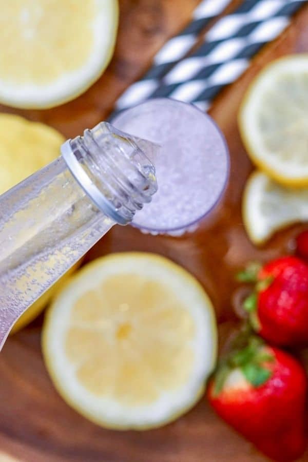 pouring lemonade into glass 