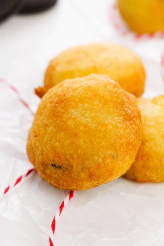 deep fried oreos on table with string by it 