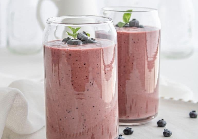 two glasses of acai smoothie on table