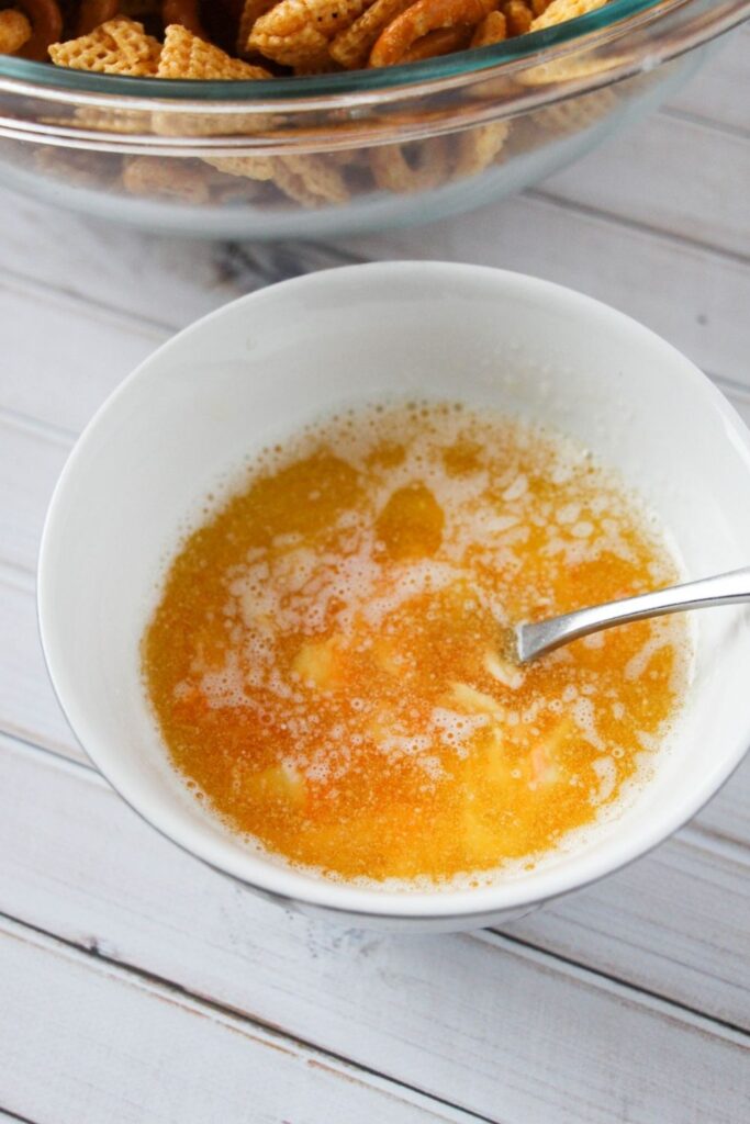 butter and buffalo sauce in a bowl with spoon