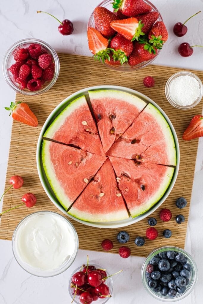 watermelon on plate with fruit all around it 