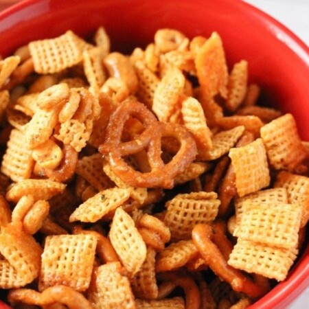 spicy chex mix in a red bowl