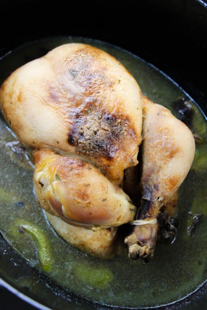 fully cooked whole chicken sitting in Crockpot 