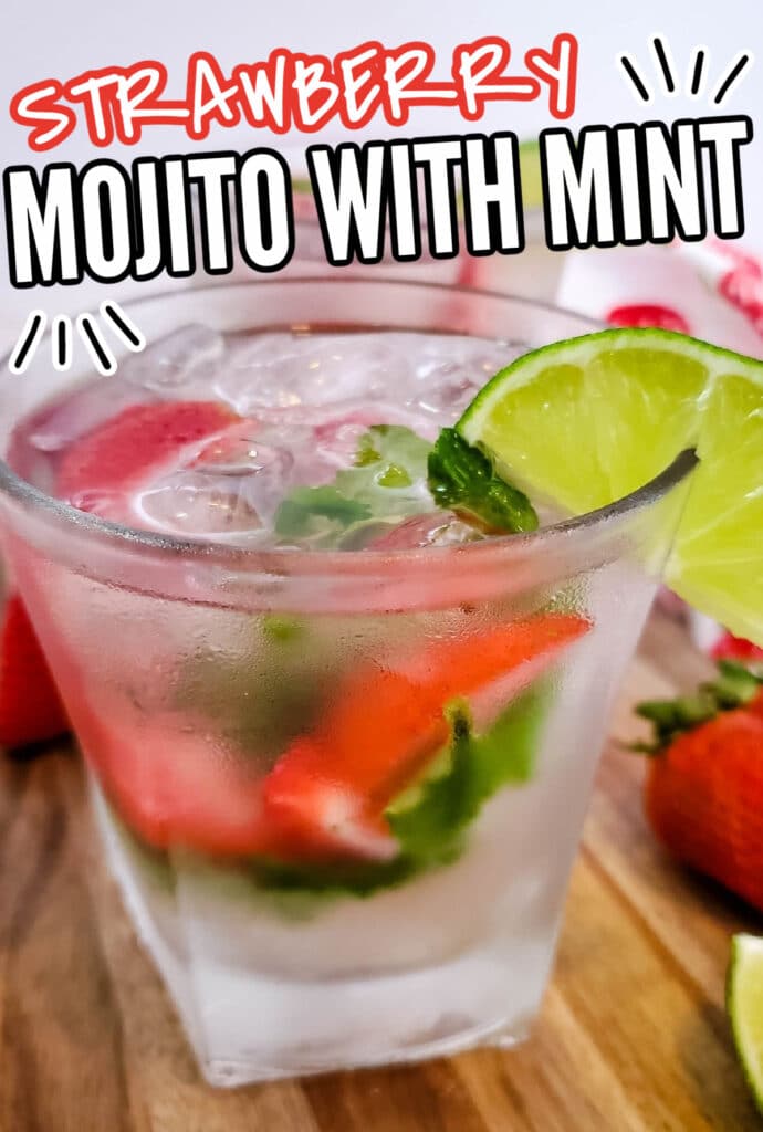 Strawberry Mojito glass close up with berries and mint muddled in cup with ice 