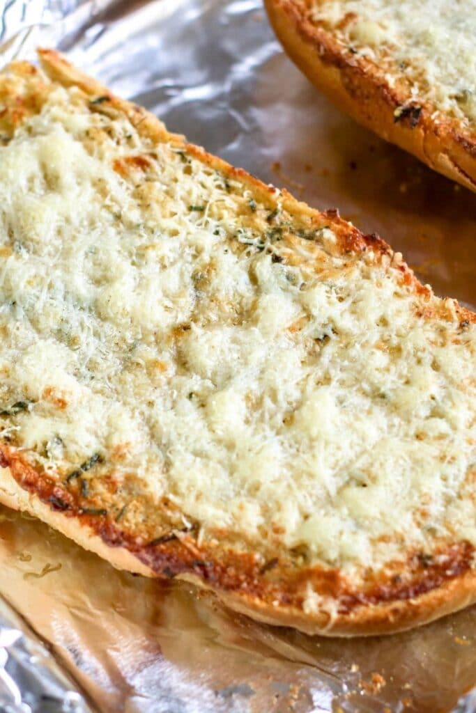 cheesy garlic bread on a aluminum foil lined pan