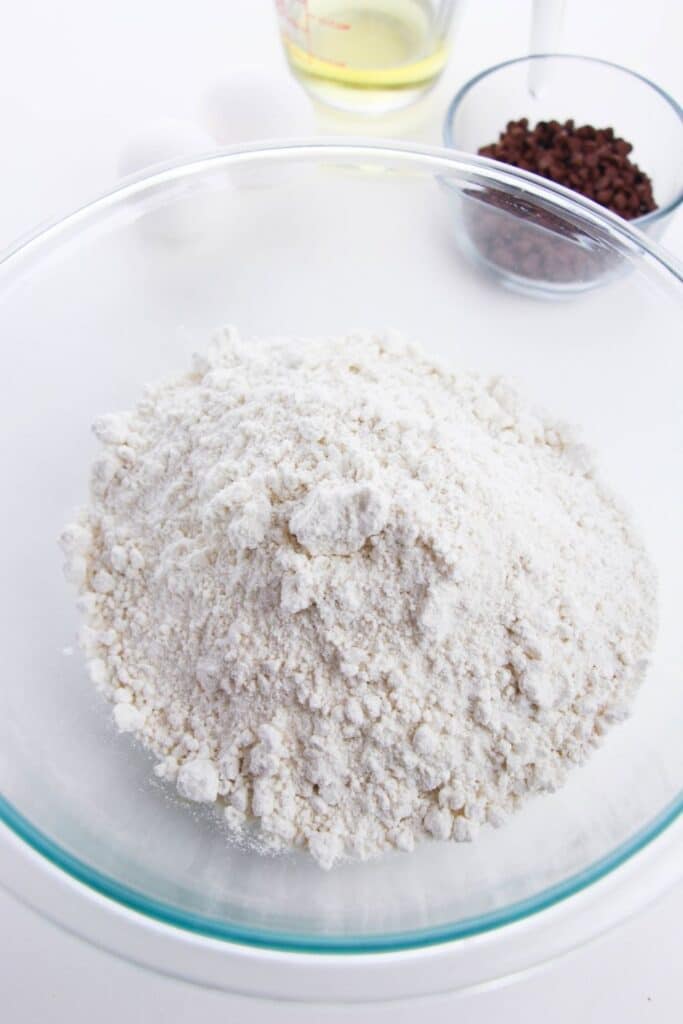 white cake mix in a glass bowl on the counter 