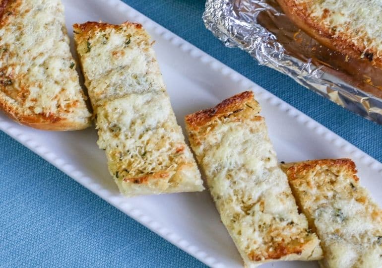 rectangle platter with sliced garlic bread on it 