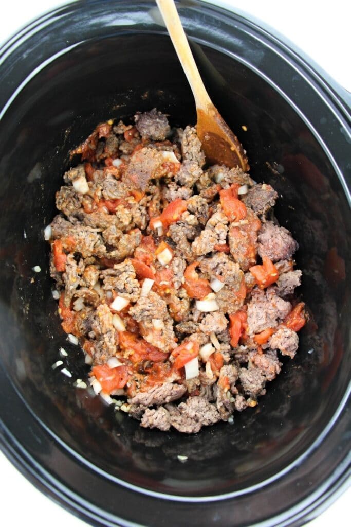 hamburger, onion, garlic, all in crock pot overhead camera shot 