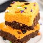 stacked cookie bars on white plates on table